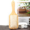 Wooden bristle brush to reduce frizz and promote natural hair shine